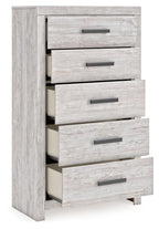 Whitewash five-drawer chest with partially open drawers and dark bar handles