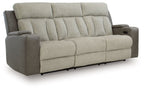 Power reclining sofa in light tan fabric with channel tufting and padded arms