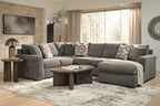 Gray sectional sofa with chaise, patterned accent pillows, and centered chaise seating