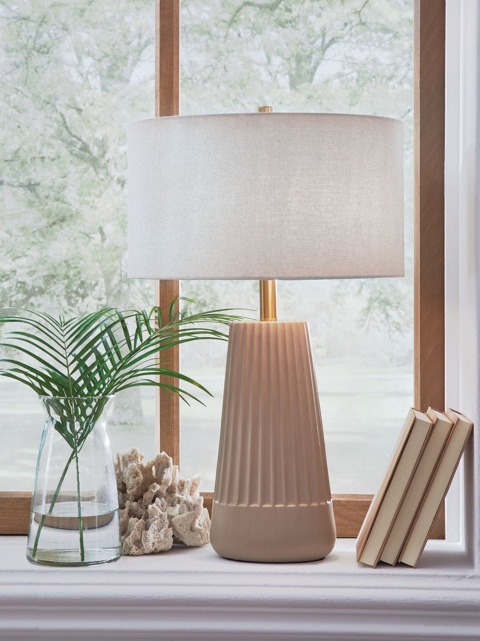 Mocha ceramic table lamp with beige drum shade on brass-toned metal stand