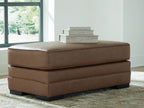 Caramel upholstered ottoman with two-tier design, padded top, and dark legs
