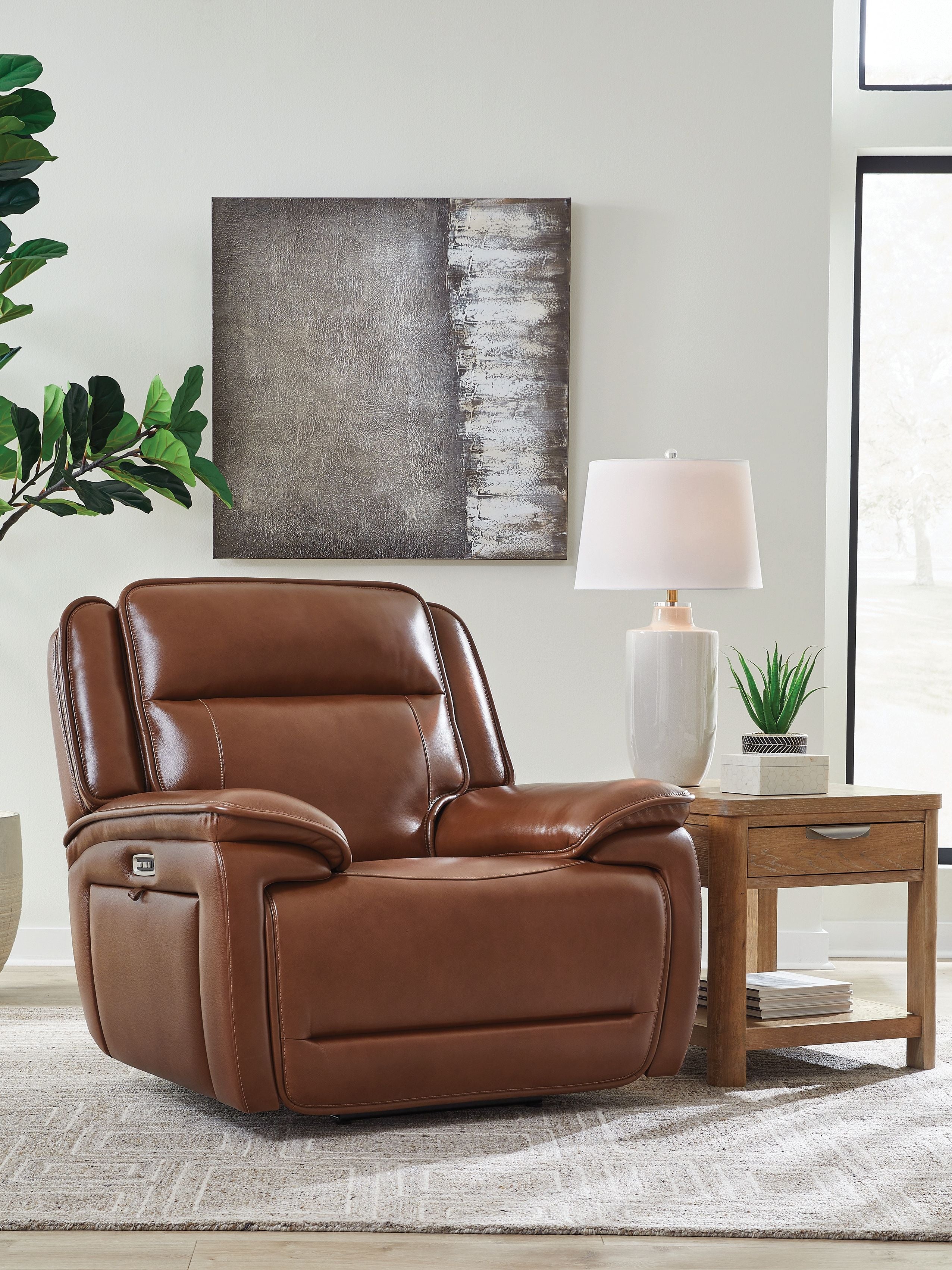 Chocolate brown power recliner with adjustable headrest and powered lever on armrest.