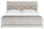 King bed with white wood frame and beige tufted headboard, upholstered panel