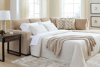 Light brown sleeper sectional with open bed and white pillows, corner chaise seating