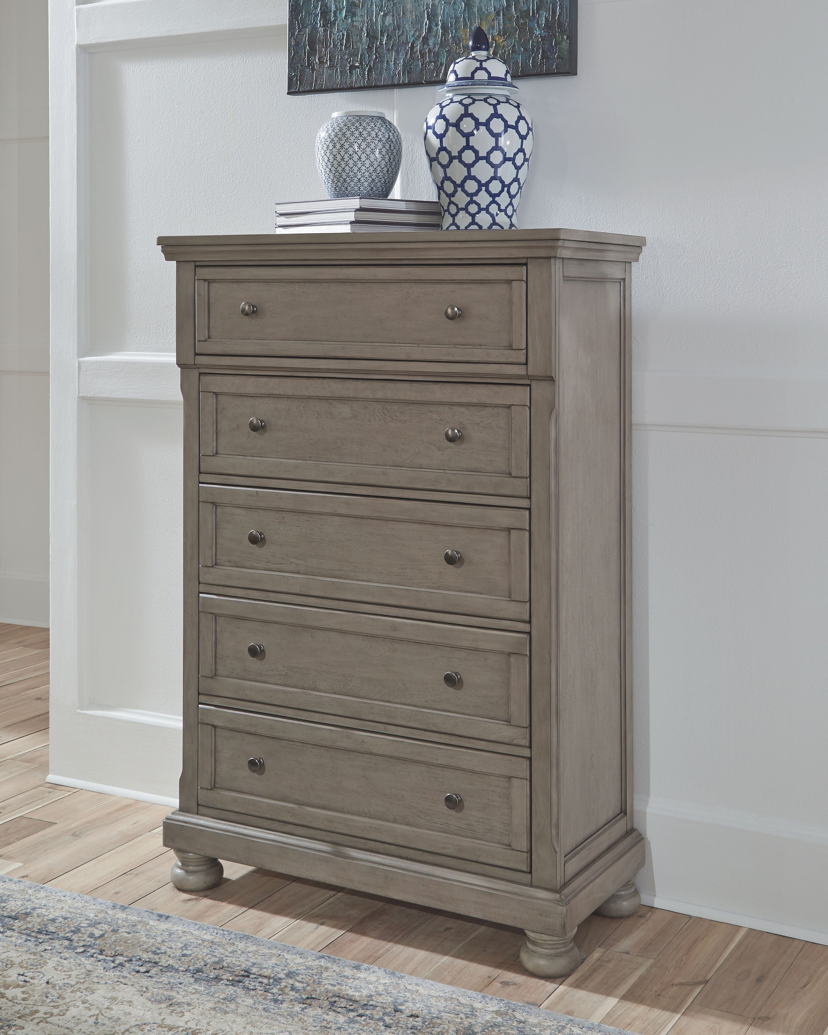 Gray chest of drawers with multiple drawers and round knobs
