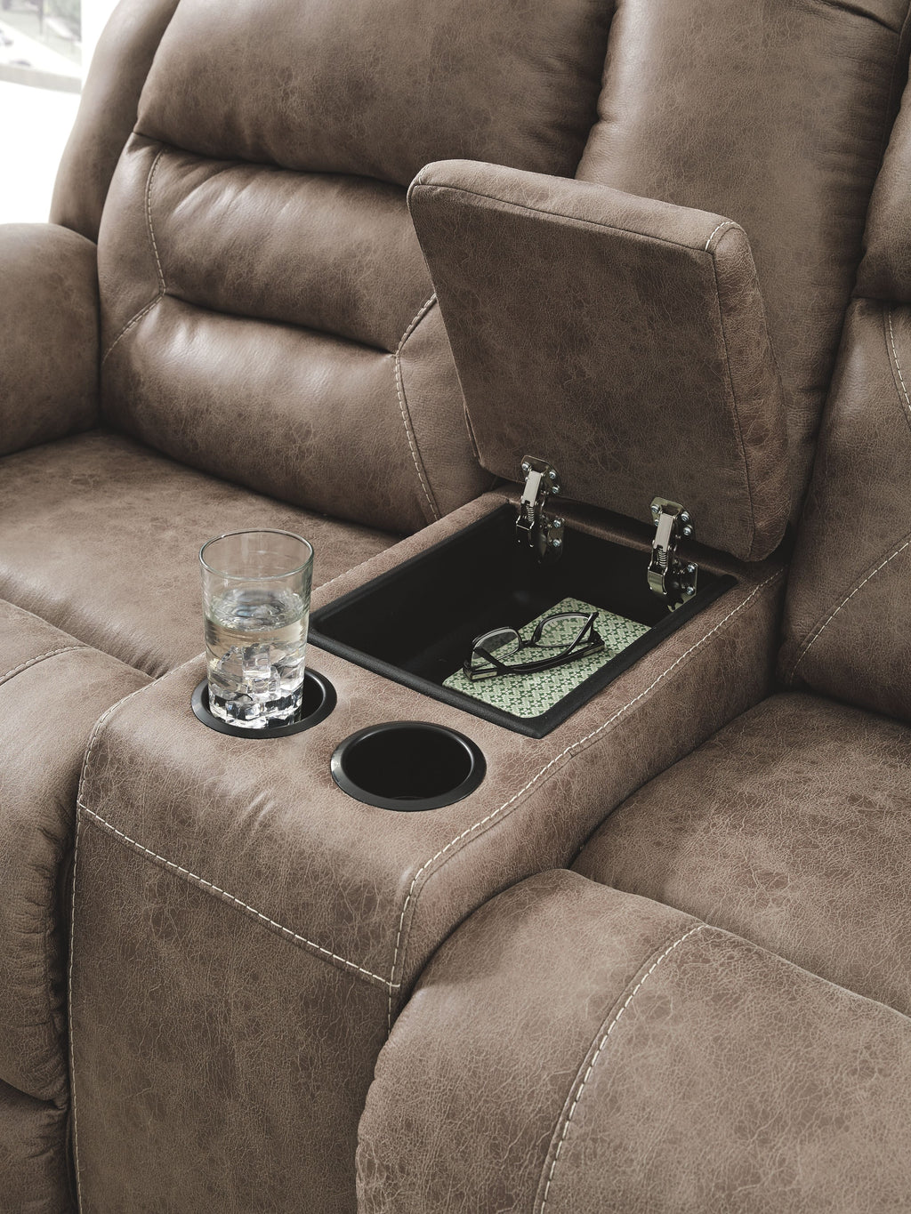 Reclining loveseat armrest console in taupe fabric with cup holder and drop tray
