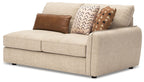 Sand upholstered RAF sofa with wide armrests, tufted-looking cushions, and three throw pillows.
