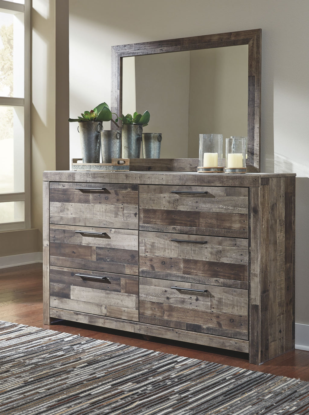 Bedroom dresser with multiple drawers, dark distressed wood finish, and mirror