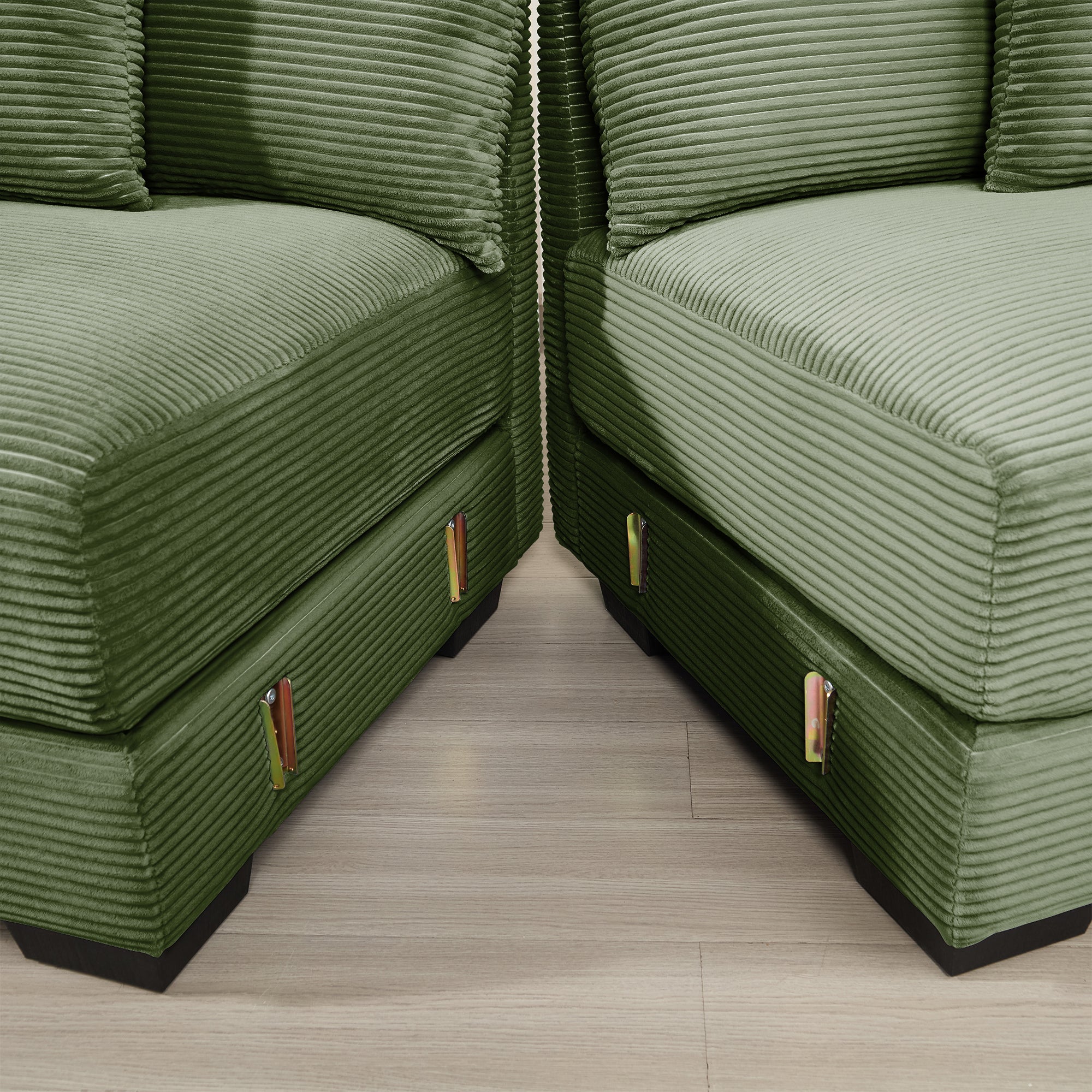 Green corduroy sectional corner with two modular ottomans and brass handles