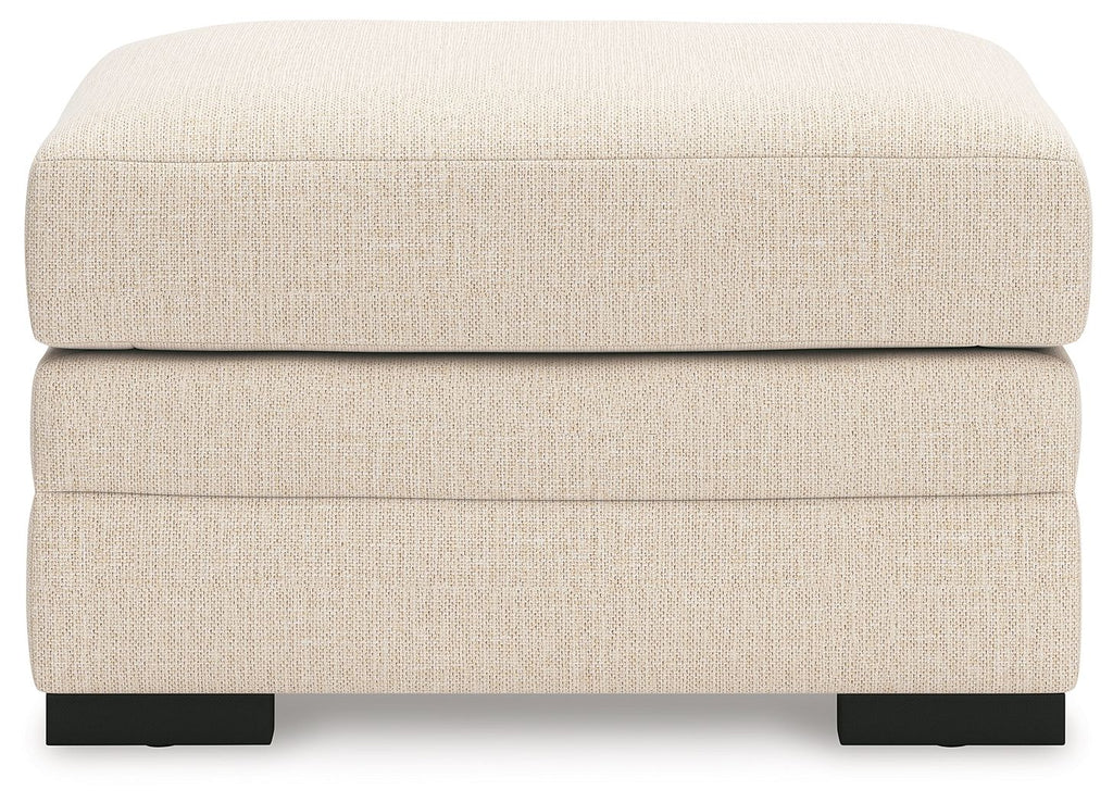 Light beige jute-look ottoman with upholstered sides and black block legs