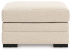 Light beige jute-look ottoman with upholstered sides and black block legs