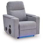 Pewter gray power recliner with speaker cutouts on armrests and padded headrest