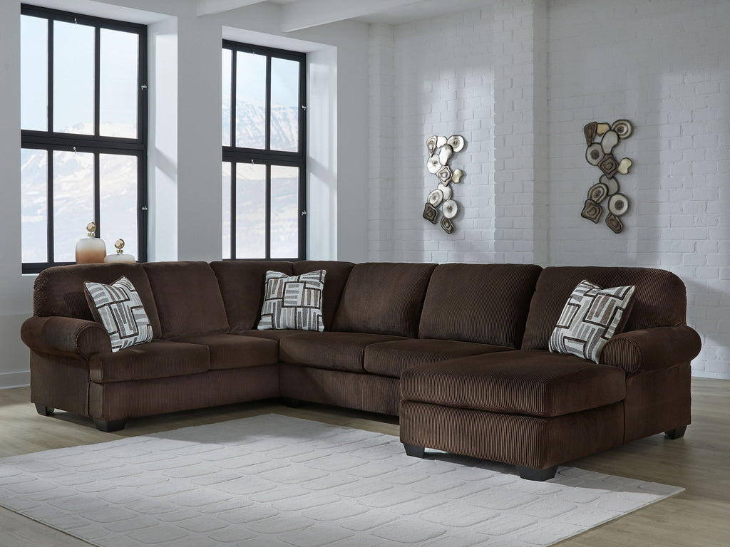 Chocolate sectional sofa with right chaise and three patterned throw pillows