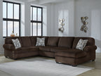 Chocolate sectional sofa with right chaise and three patterned throw pillows