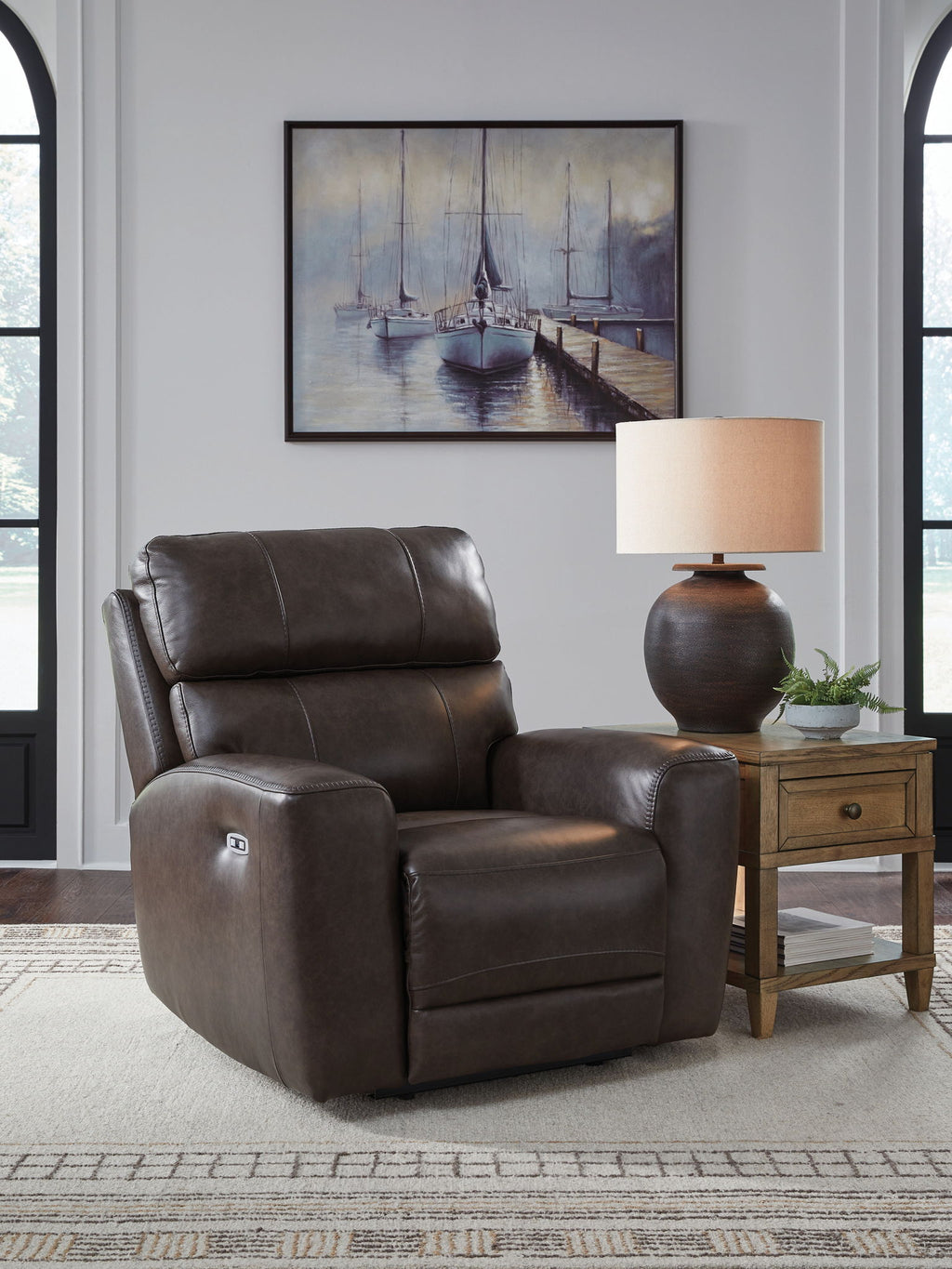 Smoke-brown recliner chair with tall headrest, padded arms, and cushioned seat