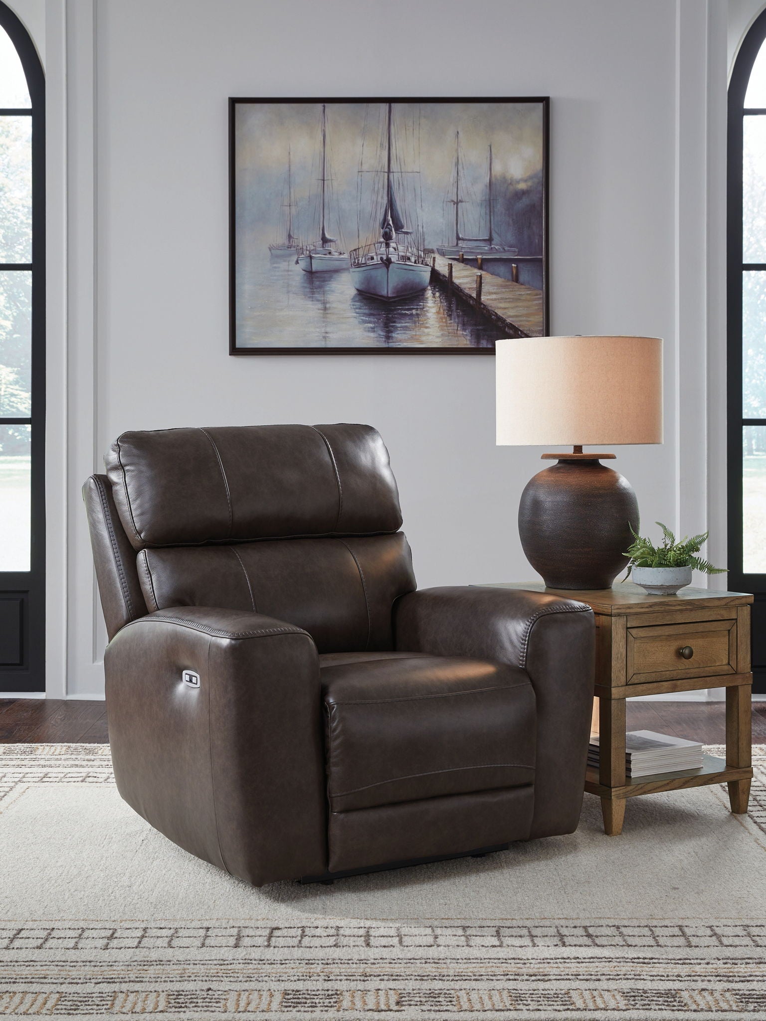 Smoke-brown recliner chair with tall headrest, padded arms, and cushioned seat