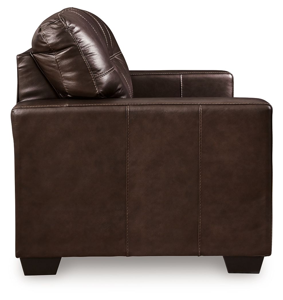 Dark brown leather-look loveseat with tufted back and built-in headrest, squared arms