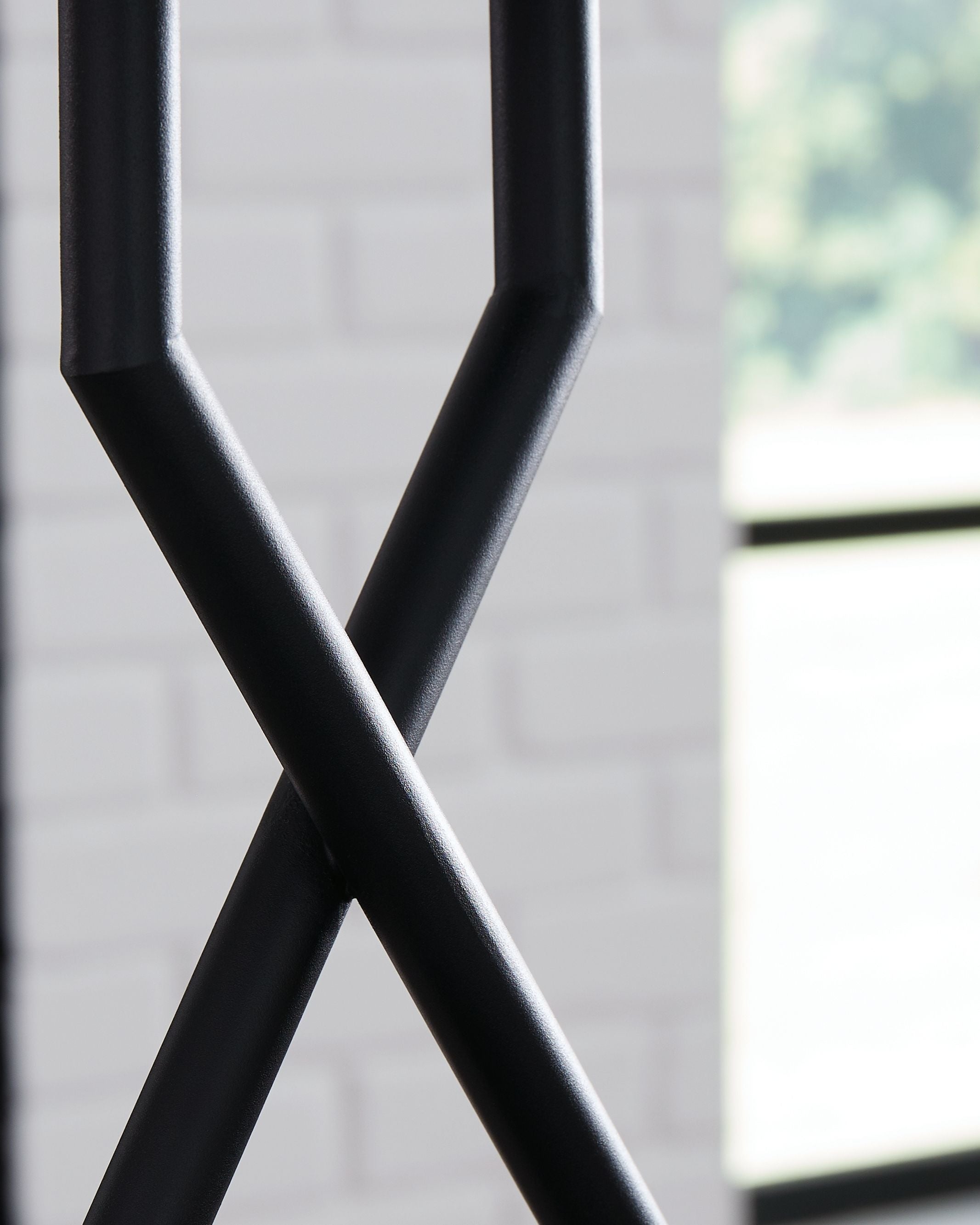 Black metal X-shaped lamp base with curved arms