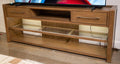 Brown wood TV stand with drawers and open media shelves with glass panels