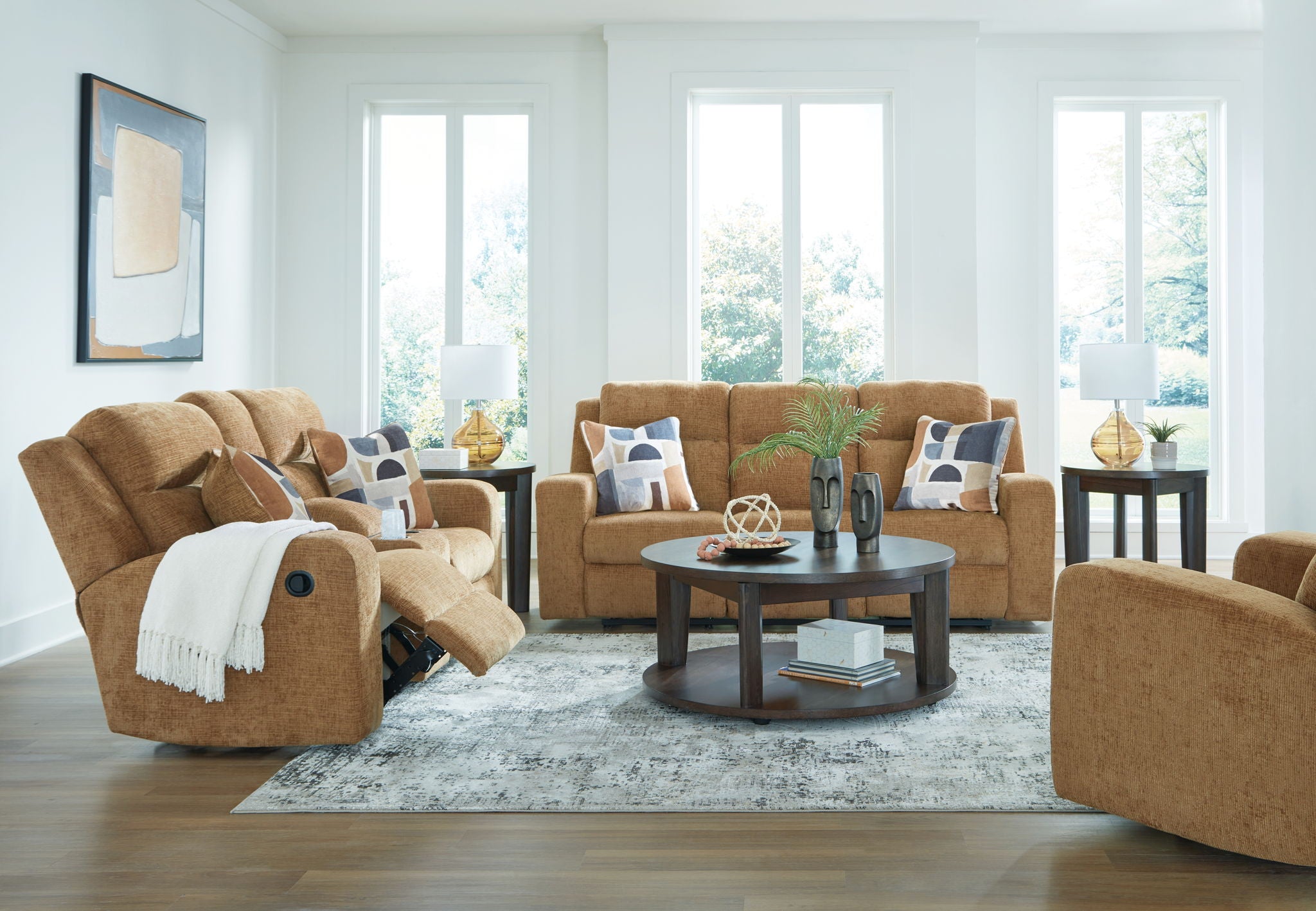 Light brown reclining living room set with recliner, sofa, and blue patterned pillows