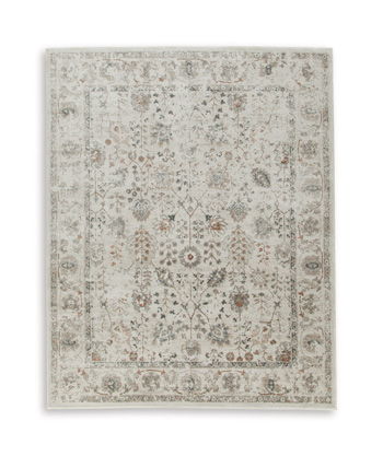 Beige rug with faded floral and geometric pattern, framed by a thin border