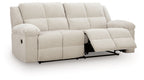 Light beige 2-seat reclining sofa with extended footrests and padded arms