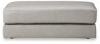 Light gray oversized ottoman with stitched top edge and low skirt