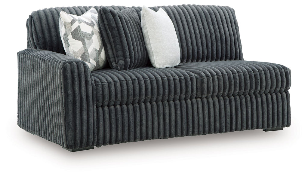 Ribbed corduroy sofa, gunmetal-gray upholstery, two throw pillows (patterned and solid)