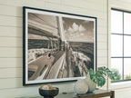 Framed sepia sailboat wall art in a dark frame, deck view over choppy ocean