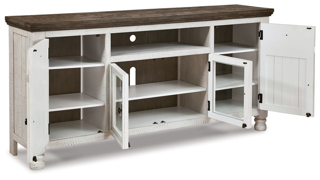 White TV stand with brown top, open storage compartments, and cabinet doors