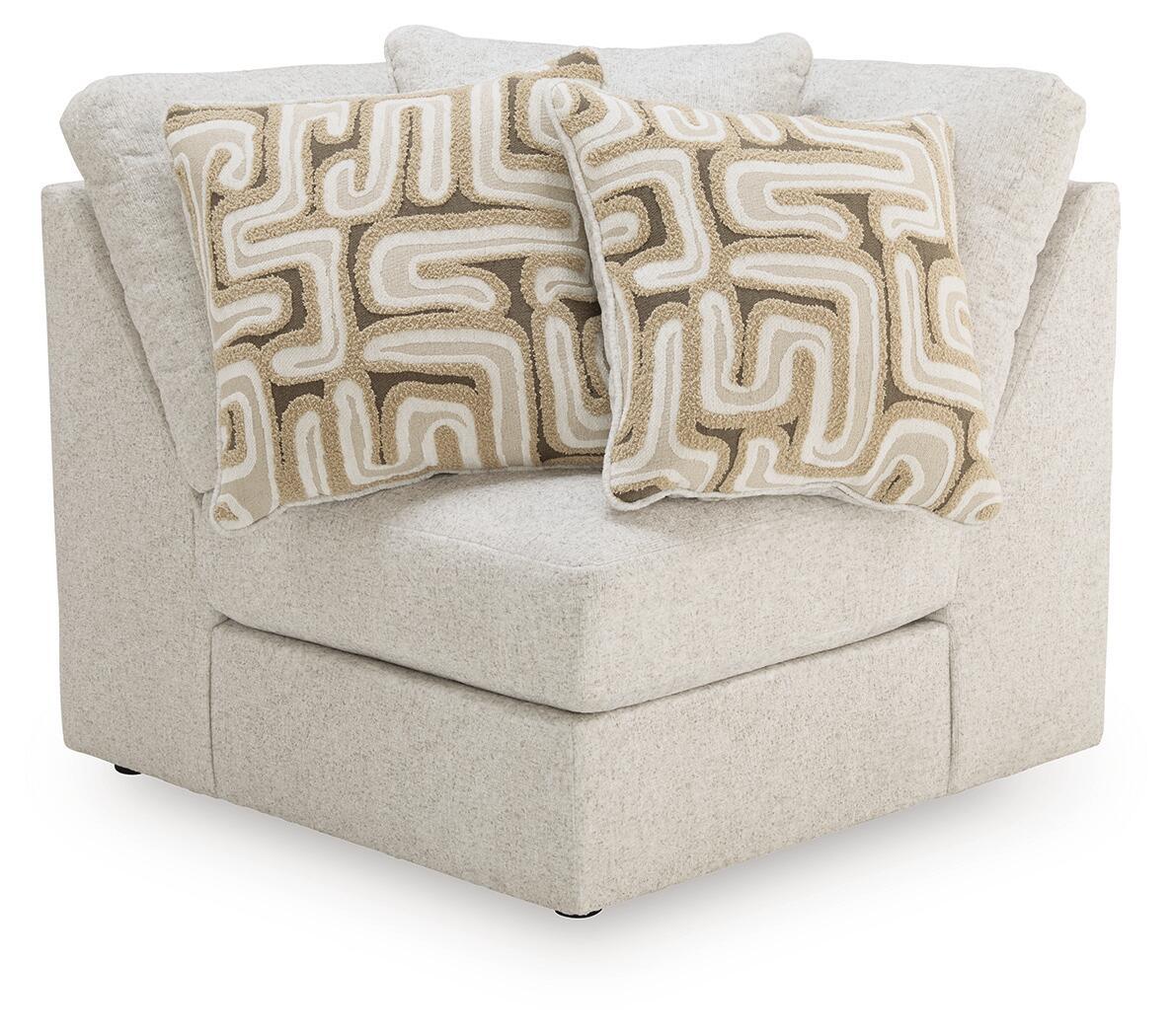 Beige upholstered sofa wedge with two patterned throw pillows