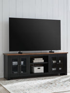 Brown-and-black TV stand with fireplace, open storage shelves and glass cabinet doors