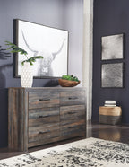 Rustic wood dresser with six drawers and black bar pulls, shown with a wall mirror above