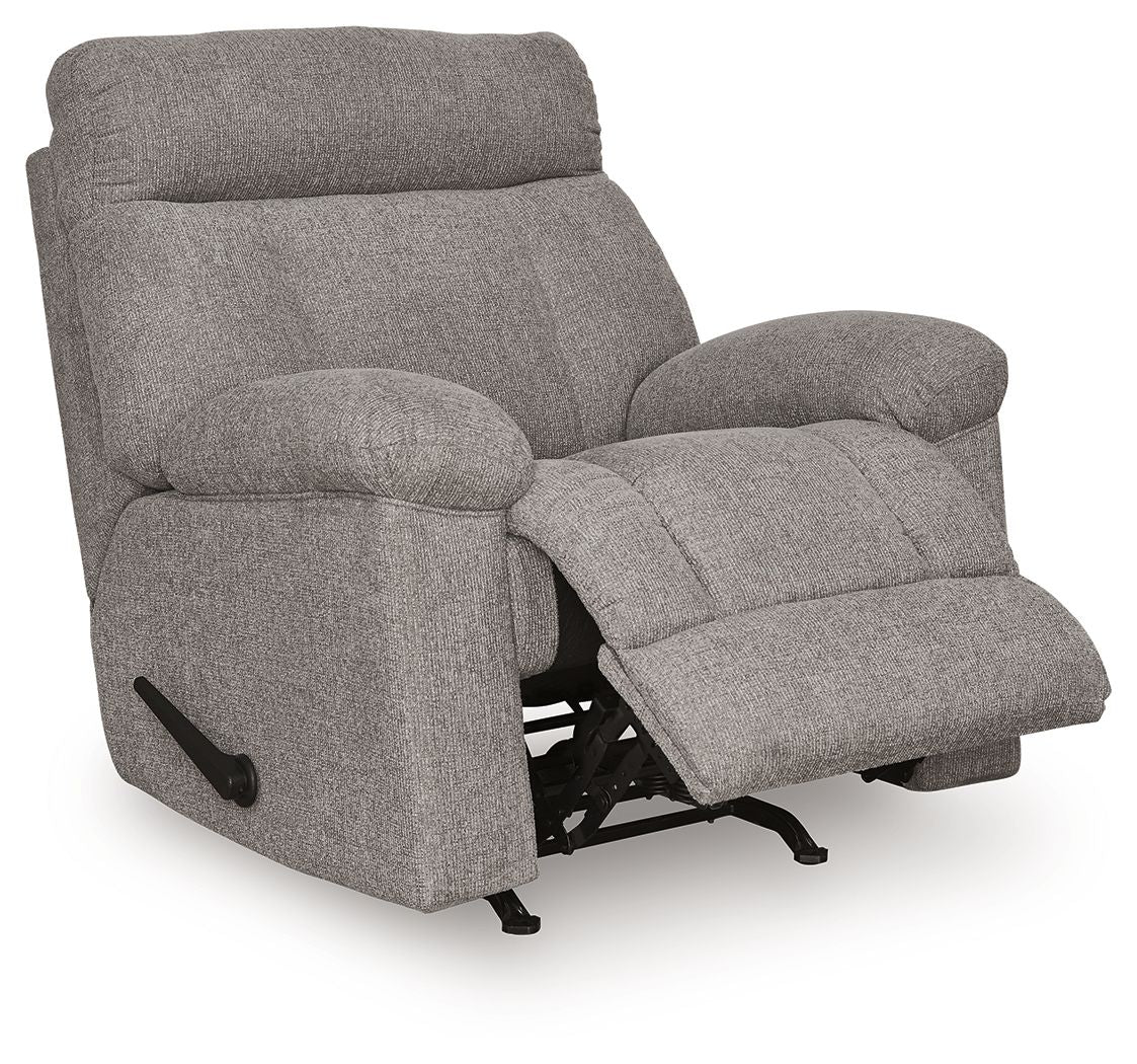 Rocker recliner chair in dark gray fabric, angled view showing recline footrest
