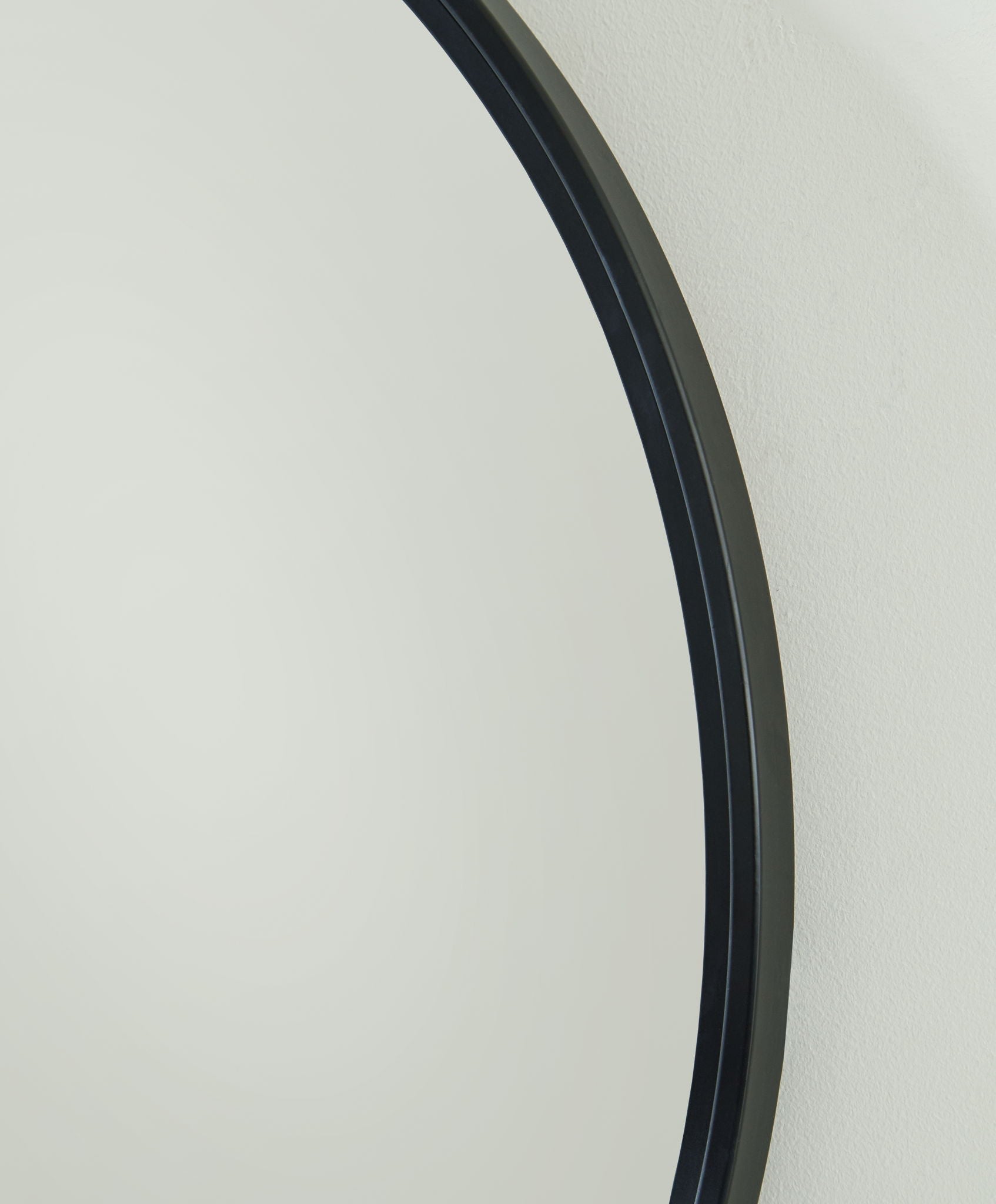 Brocky black round accent mirror frame edge close-up