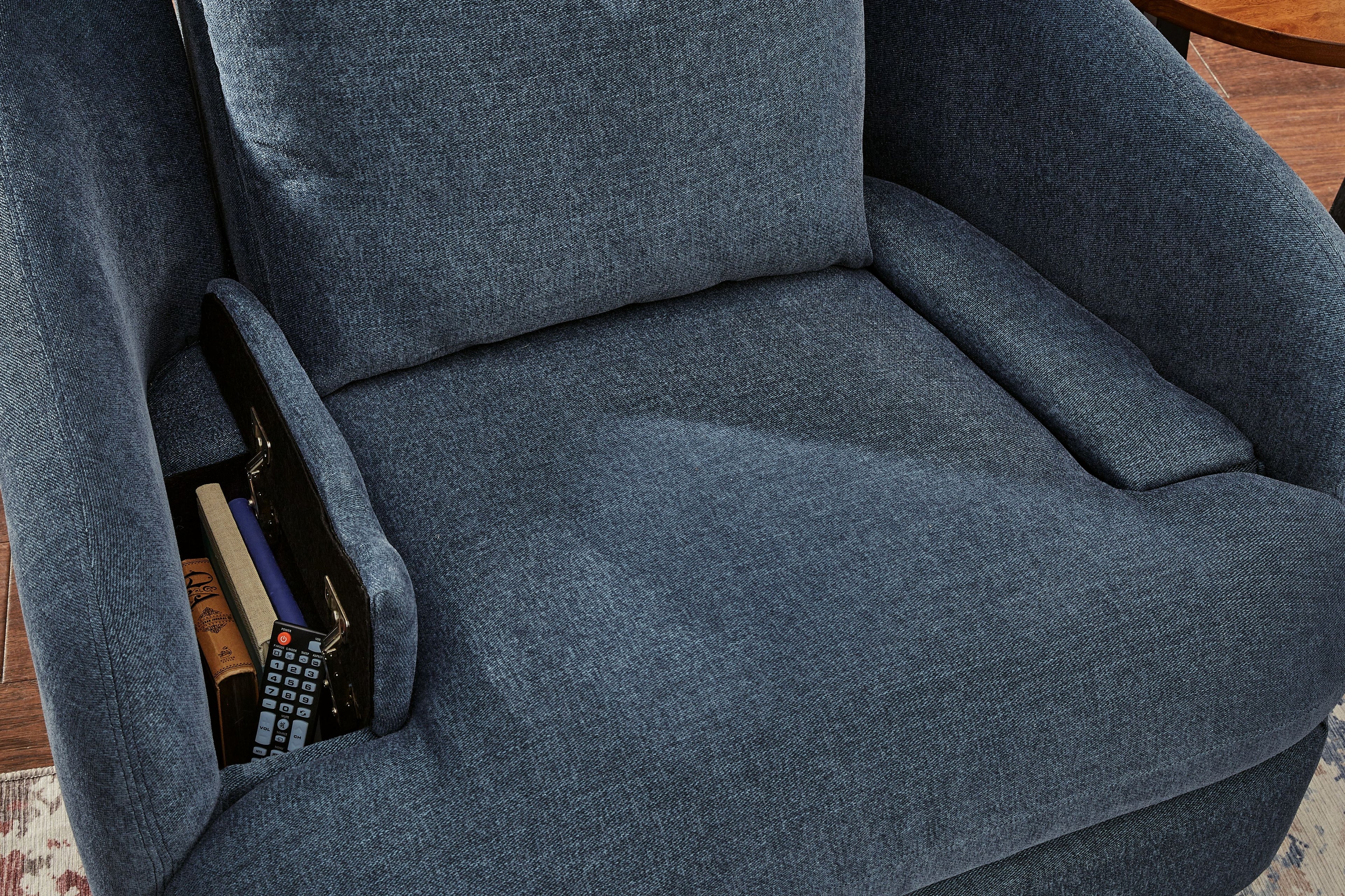 Swivel glider recliner chair in dark blue fabric, arm storage pocket with remote.