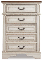 Chipped white chest of drawers with five drawers and decorative metal pulls