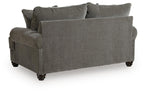 Gray upholstered loveseat with rounded arms, dark legs, and solid back cushions
