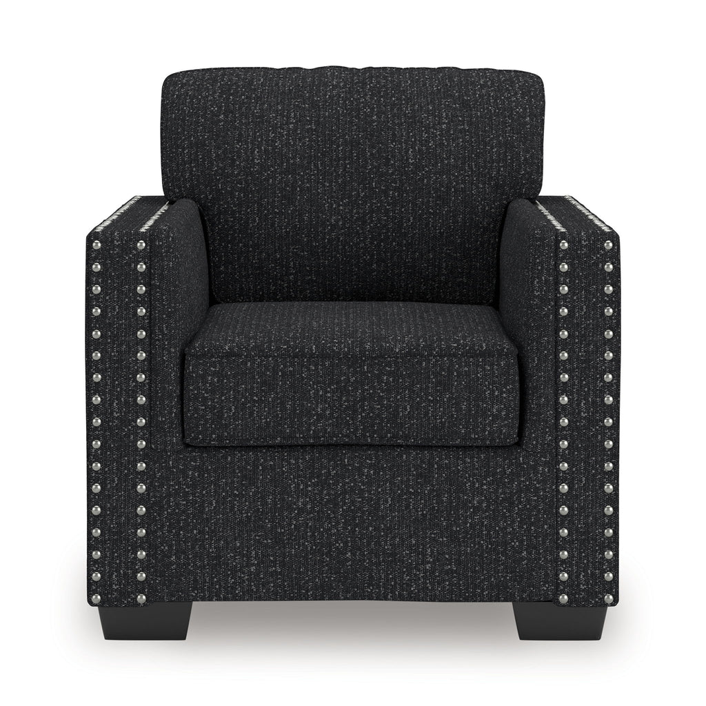 Dark charcoal upholstered armchair with square arms, seat cushion, and silver nailhead trim.