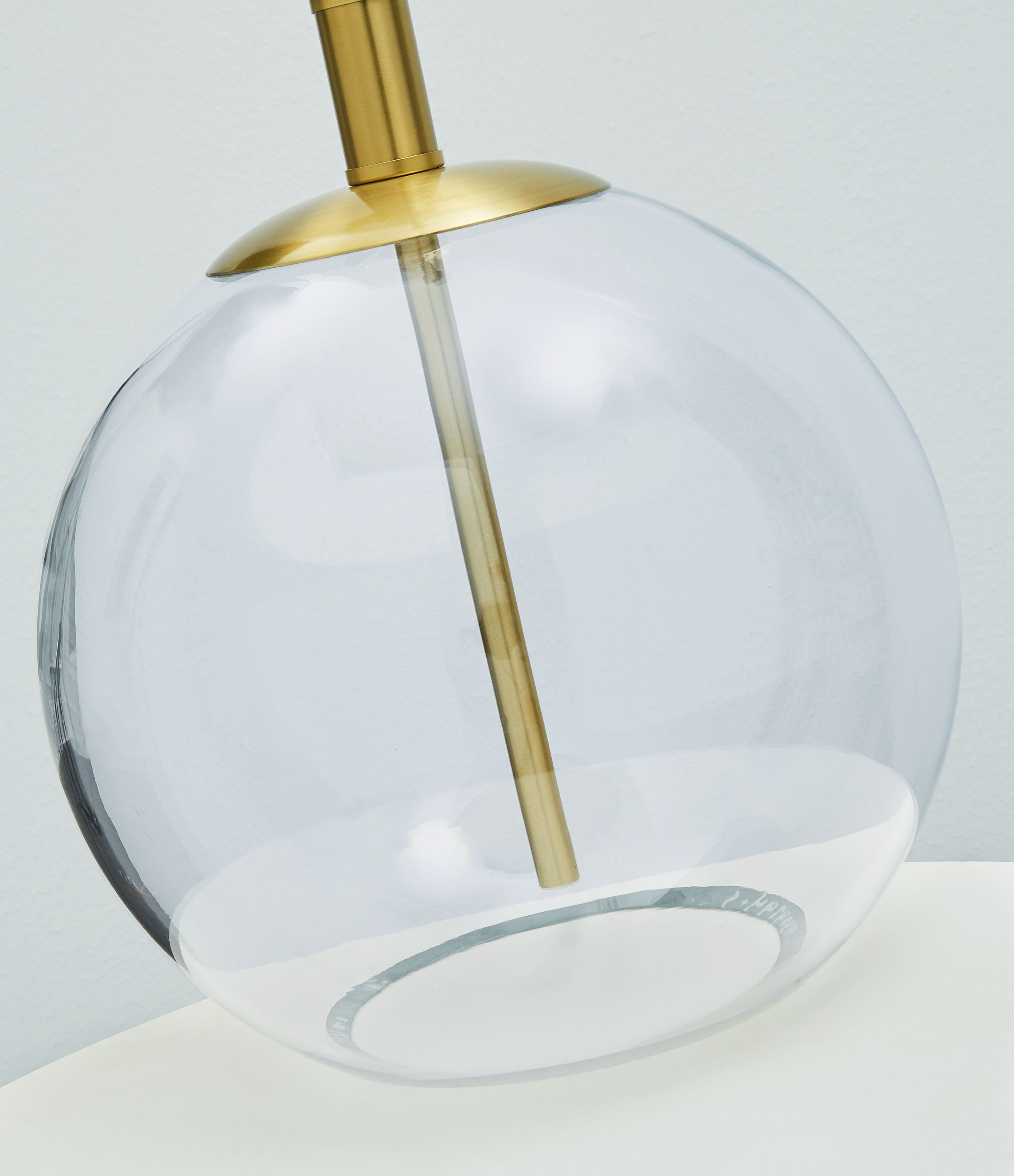 Clear glass globe table lamp with brass stem and top mount
