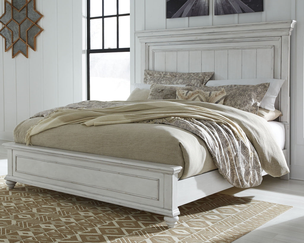 White panel bed with tall headboard, decorative bedding and pillows