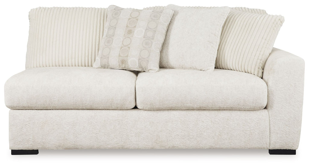 Ivory upholstered two-seat sofa with ribbed back cushions and rounded arms