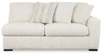 Ivory upholstered two-seat sofa with ribbed back cushions and rounded arms