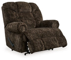 Chocolate brown fabric wall recliner with extended footrest, tufted back, and armrest lever