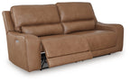 Light brown power reclining sofa with side control and padded adjustable headrests