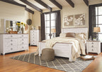 White nightstand with three drawers, arched metal pulls, and turned legs