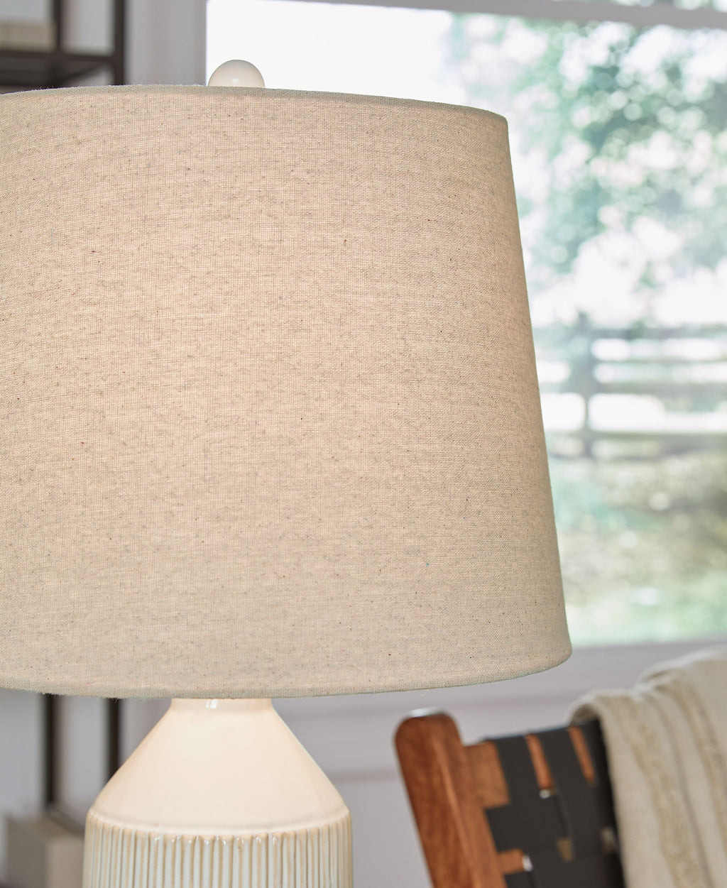 Ceramic table lamp shade with off-white drum fabric and top of textured base