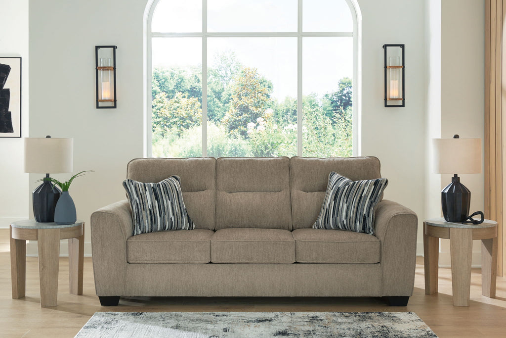 Light brown fabric sofa with two striped pillows, centered front view