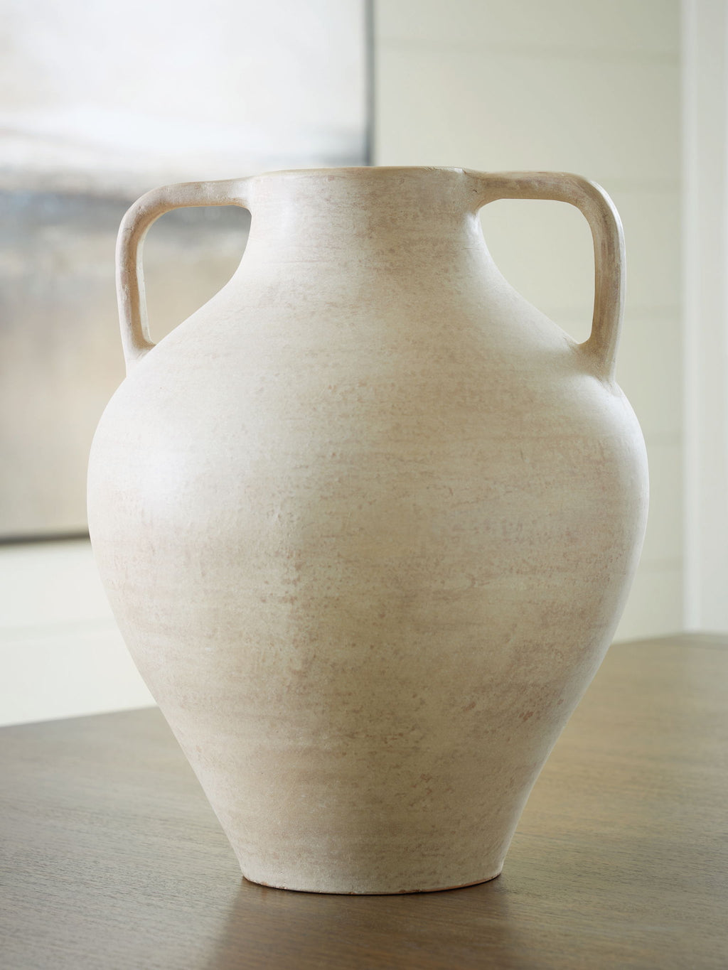 Beige ceramic vase urn shape with side handles and flared top opening
