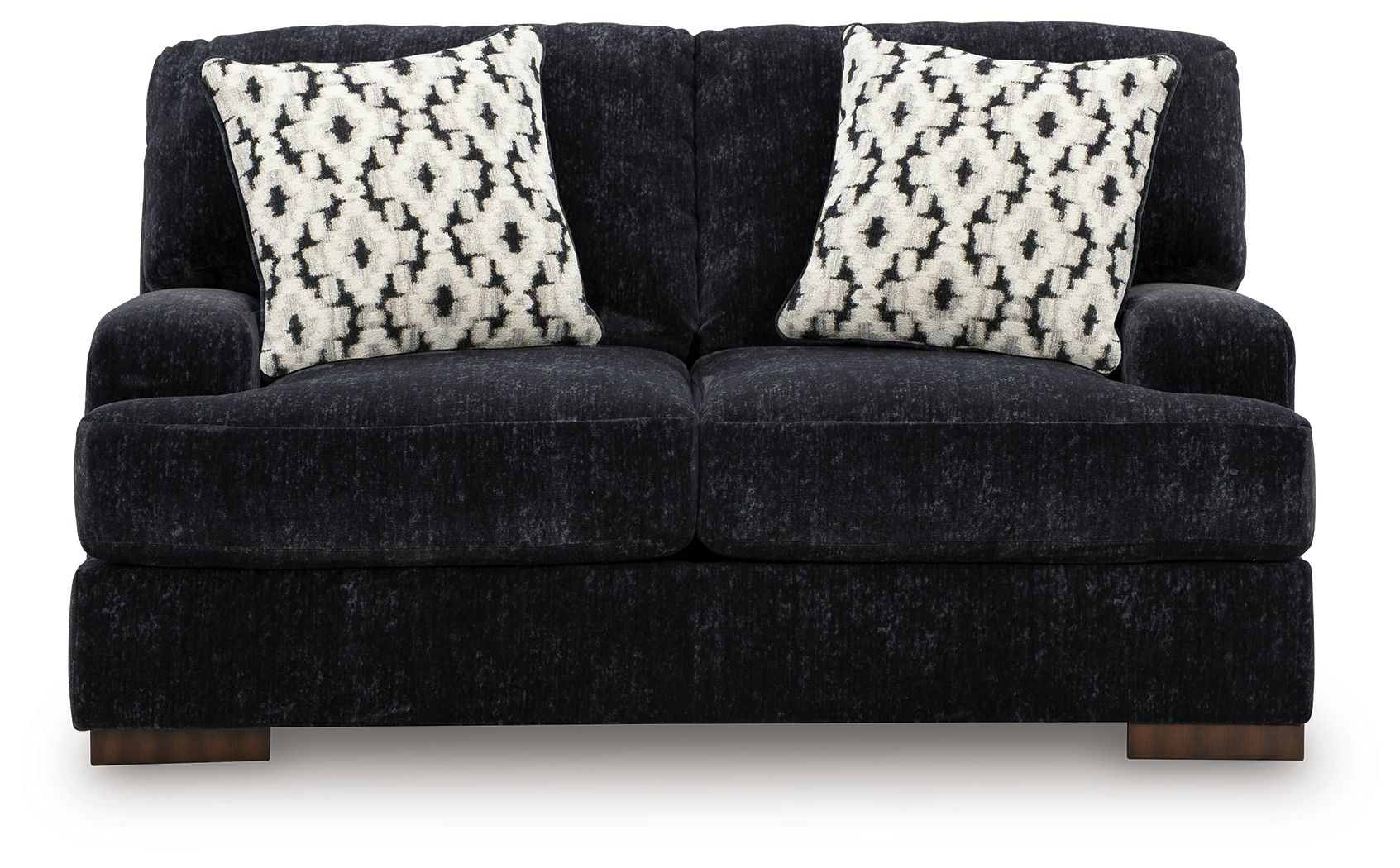 Dark charcoal loveseat with two black-and-white patterned throw pillows, wide seat